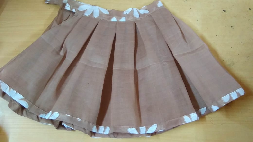 Box pleated skirt Stiched by our student jency. For belt and bottom she used printed cloth for decoration, even for school uniform children wear these types of by box pleatted skirt.